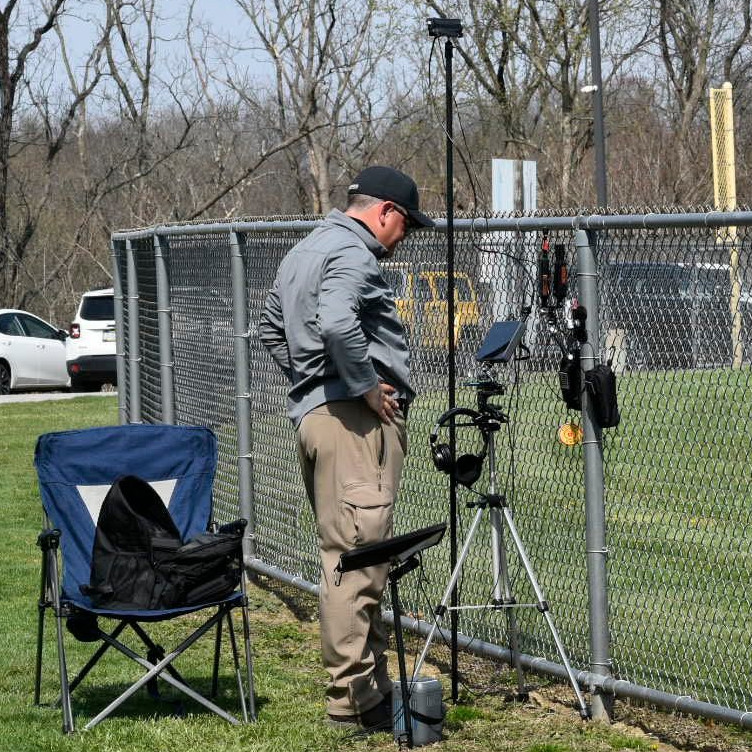 Bill Littler filming at a softball field