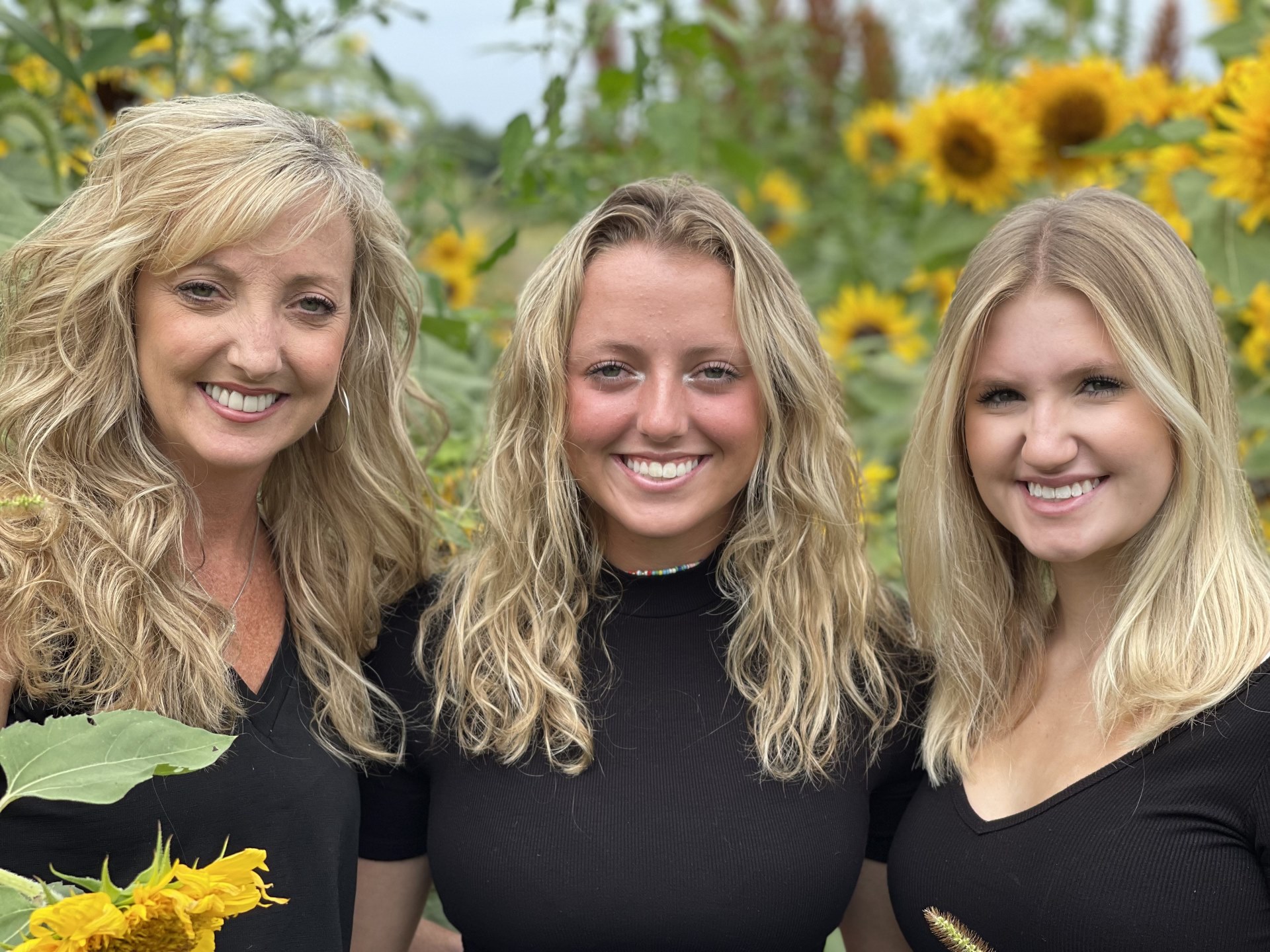 Jill with her daughters in a sunflower field